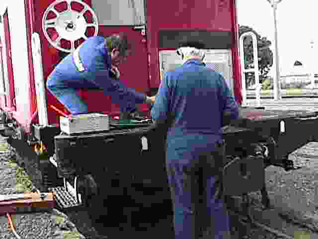 The guys removing rust from the deck